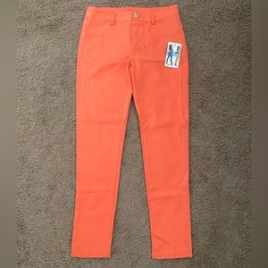 Orange skinny slacks.